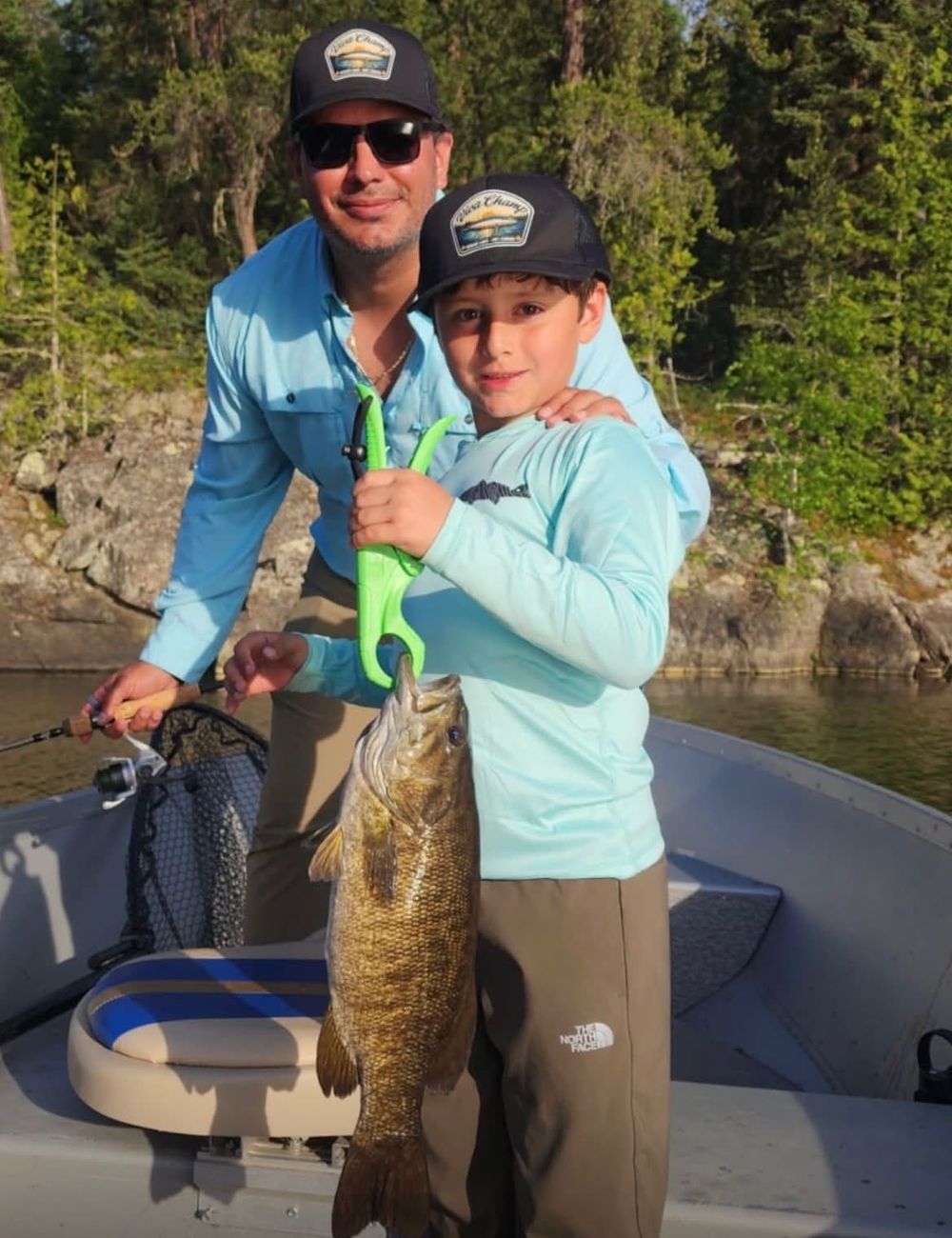 Two generations in the boat with a big smallmouth bass