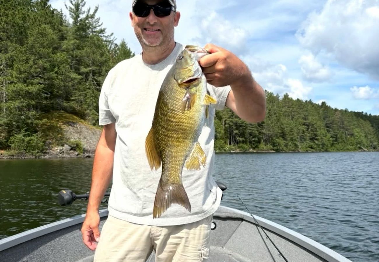 Angler standing in the boat with a walleye