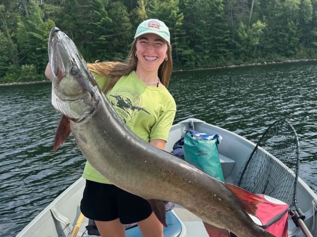 Angler holding a big muskie caught at Wilderness Fishing Oasis